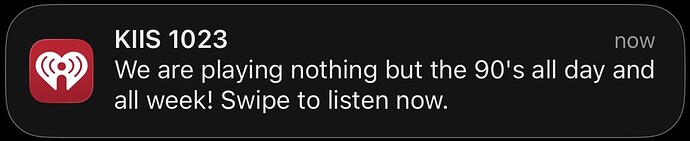 iHeart notification from KIIS 1023: "We are playing nothing but the 90's all day and all week! Swipe to listen now."